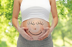 Close up of pregnant woman belly with smiley