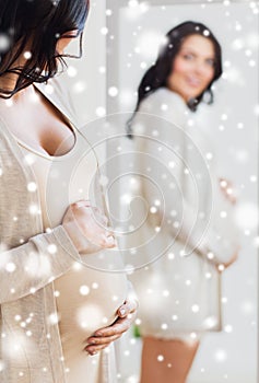 Close up of pregnant woman looking to mirror