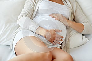 Close up of pregnant woman lying in bed at home