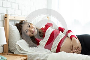 Close up Pregnant Woman lying on bed smile and sleep with big belly