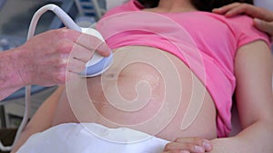 Close Up Of Pregnant Woman And Partner Having Ultrasound