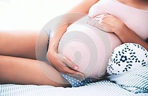 Close-up pregnant woman`s belly.