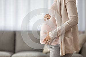 Close up of pregnant woman touch baby bump
