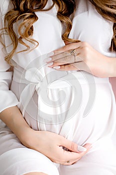 Close-up of a pregnant woman touching her belly photo