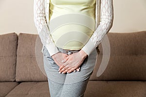 Close up of pregnant women urine urgency at home. pregnant urinary incontinence concept