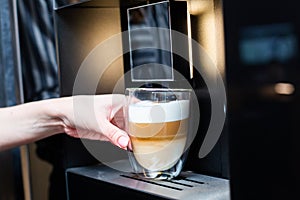 Close-up. Preparation of coffee latte in a modern coffee machine.