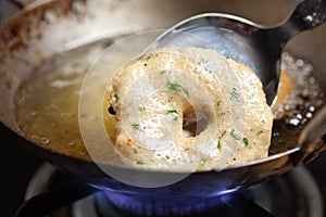 Close-up of Preparation of  dahi vada - Bade is deep frying in vegetable cooking oil in iron kadai.  for  preparation of chaat