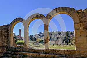 Close up of the preserved roman arches and the tower of the San Romolo Cathedral, Fiesole, Florence, Tuscany, Italy