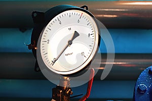 Close-up of the pressure gauge on the background of pipes. The gauge arrow shows zero. No pressure in the system