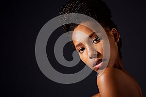 Close up pretty african woman with naked shoulders looking at camera