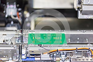 Close up print circuit board pcb on conveyor of PCB LED SMT automatic pick and place machine for assembly electronic board