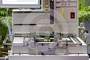 Close up print circuit board pcb on table jig of IC placer automatic pick and place machine for assembly electronic board