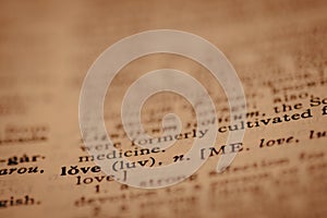 Close up of printed dictionary definition of the word love, with limited focus
