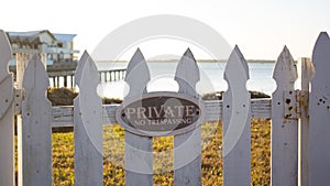Close up - Private No Trespassing sign picket fence