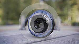 Close up of professional camera lens lying on a rotating children roundabout. Action. Photography concept. forgotten