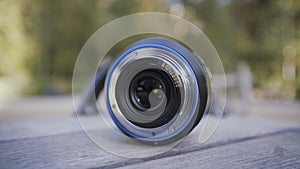 Close up of professional camera lens lying on a rotating children roundabout. Action. Photography concept. forgotten