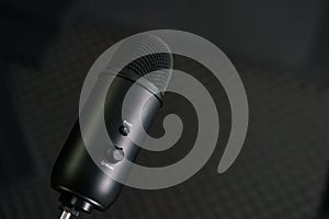 Close-up of professional condenser microphone on a black background