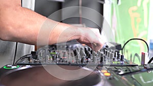 Close up of professional dj playing electronic music, spinning tunes on digital controller