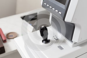 Close up of professional eye testing equipment. Modern eye testing device standing in the lab. Tonometer in