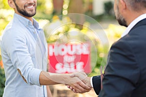 House seller shaking buyer`s hand