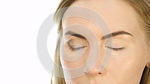 Close-up of professional make-up artist doing everyday makeup, puts powder on womans cheeks with brush