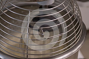 close up of a professional mixer blending cream for chantilly produce in professional kitchen of bakery