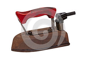 Close-up of a professional old rusty electric tailor iron or flatiron with a red handle and vintage power plug isolated on a white