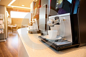 Close-up of professional self-service coffee machines in the restaurant lounge and waiting area of the airport departure terminal