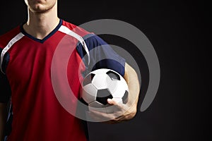 Close Up Of Professional Soccer Player With Ball In Studio