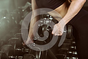 Close Up Professional sport fitness woman ifting weight in gym.