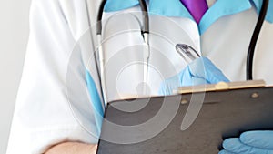 Close-up of professional therapist hands signing medical document on clipboard.