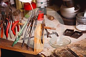 Close-up professional tools on a workshop background. Expensive jewelry making. Accessory manufacturing.