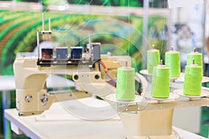 Close up of a professional typewriter for tailoring at a manufacturing plant. sewing machine on blurred background