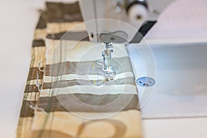 Close up of a professional typewriter for tailoring at a manufacturing plant. Textile: Industrial embroidery machine. Computerized