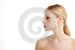 Close-up profile face of beautiful young woman posing at isolated white background