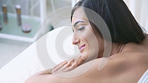 Close up profile of woman relaxing on the couch and slumbering at camera in 4K