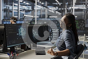 Close up of programmer in data center using AI powered tech to run simulations