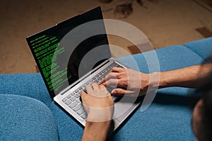 Close-up of programmer developer coding software program script on laptop display, typing keyboard for remote work at