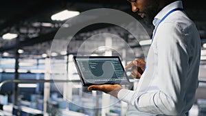 Close up of programmer swiping on tablet display in data center, checking code