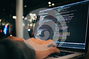 A close-up of a programmer& x27;s hands and keyboard. A programmer is writing software code by hand.