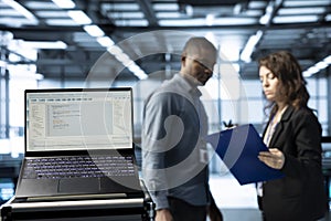 Close up of programming language on notebook display in server room