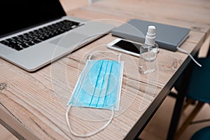 Protective mask and bactericidal spray on the office Desk
