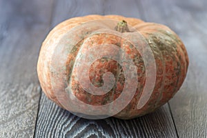 Close-up pumpkin on a wooden background. The concept of a rich harvest, organic products, vegetables.