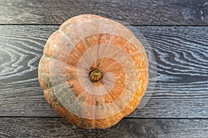 Close-up pumpkin on a wooden background. The concept of a rich harvest, organic products, vegetables.