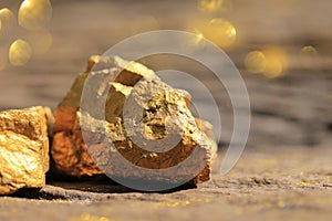 Close up pure gold minerals with golden light on old wooder background, investment and business concept
