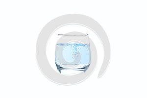 Close up purified blue water glass for drink on white background.