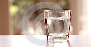 Close up the purified fresh drink water from the bottle on table