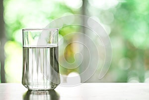 Close up purified fresh drink water from the bottle on table in