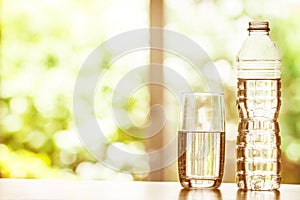 Close up the purified fresh drink water from the bottle on table photo