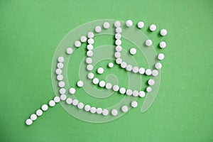 Close-up of push pins forming leaf over green background depicting environmentalism photo